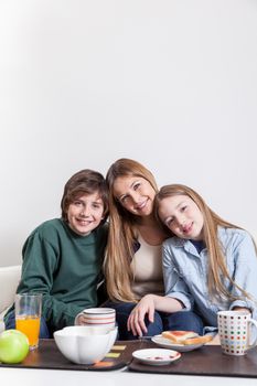 Woman having the breakfast with your sons