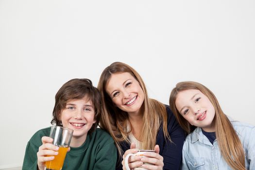 Happy family drinking juice together