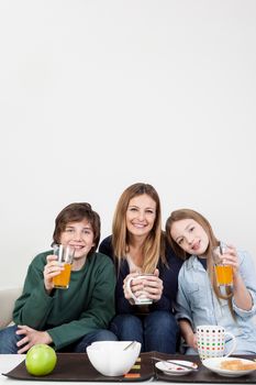 Happy family drinking juice together