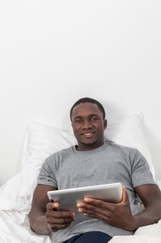 Man looking at camera and holding his tablet