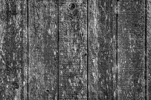 Black and white image of the side of an old barn.