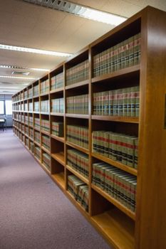 Volumes of books on bookshelf in library at the university