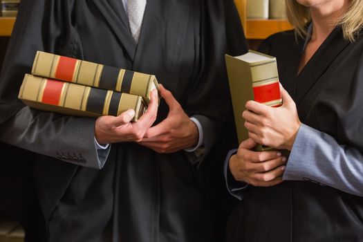 Lawyers holding books in the law library at the university