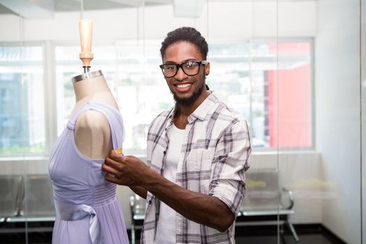 Portrait of male fashion designer and mannequin