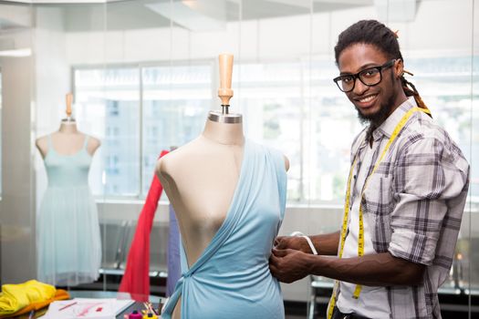 Portrait of male fashion designer and mannequin