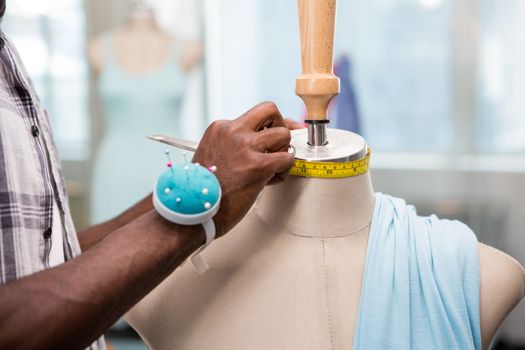 Close up of male fashion designer and mannequin