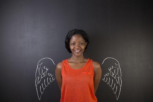 South African or African American woman teacher or student angel with chalk wings on blackboard background