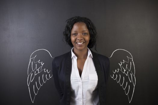 South African or African American woman teacher or student angel with chalk wings on blackboard background