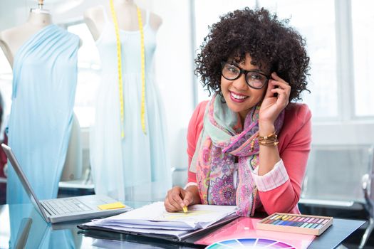 Portrait of attractive female fashion designer at work