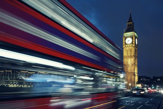 Big Ben, one of the most prominent symbols of both London and England, as shown at night along with the lights of the cars passing by