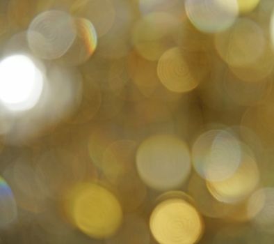 Defocused golden light spots as abstract background                               