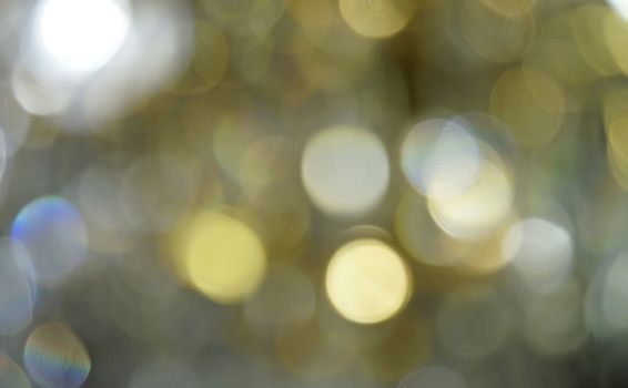 Defocused golden light spots as abstract background                               