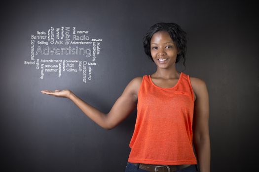 South African or African American woman teacher or student against blackboard background with chalk advertising diagram