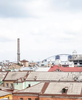 city landscape with old roofs and dish antennas