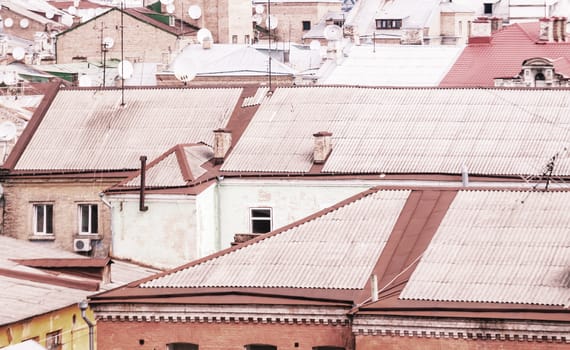 city landscape with old roofs and dish antennas