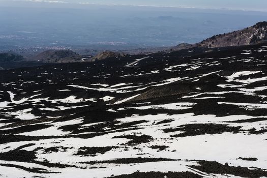 Etna mountain landscape, volcanic rock and snow, Sicily, Italy