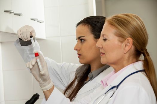 A young and an old women doing an experiment