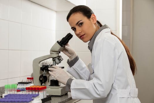 woman looking at the microscope