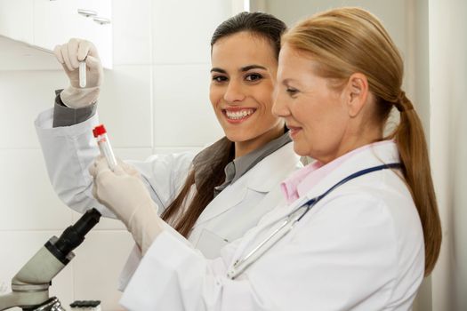 couple in a lab looking the tube