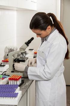 woman looking at the microscope