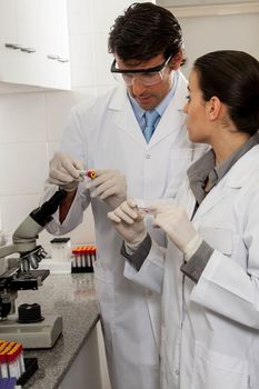 couple looking at the tubes in the lab