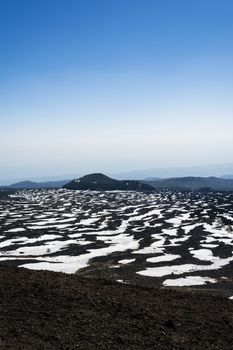 Etna mountain landscape, volcanic rock and snow, Sicily, Italy