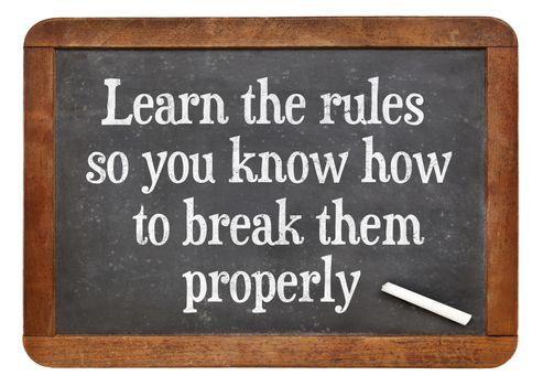 Learn the rules, so you know hot to break them properly. INspirational words on a vintage slate blackboard