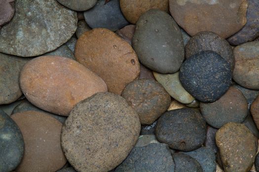 Pile of round peeble stones for background