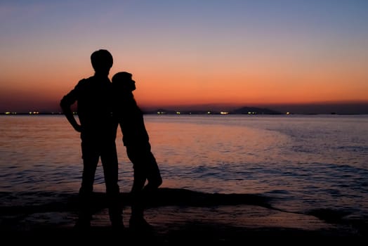 Silhouette of sweet couple with romantic place, Sunset sky at sea