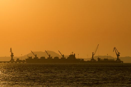 Shipping port in the sea with sunset sky