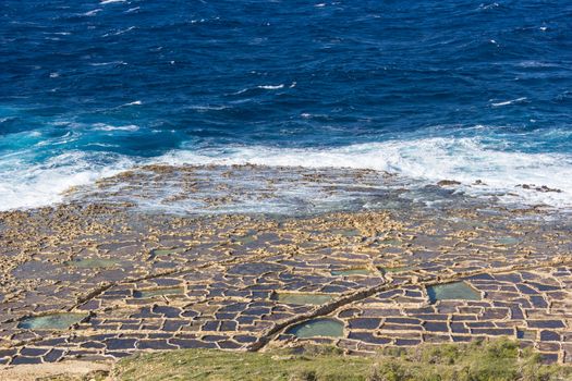 ancient salt in Qbajjar island of Gozo are still used for the production of sea salt