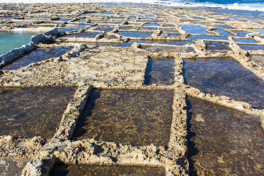 ancient salt in Qbajjar island of Gozo are still used for the production of sea salt