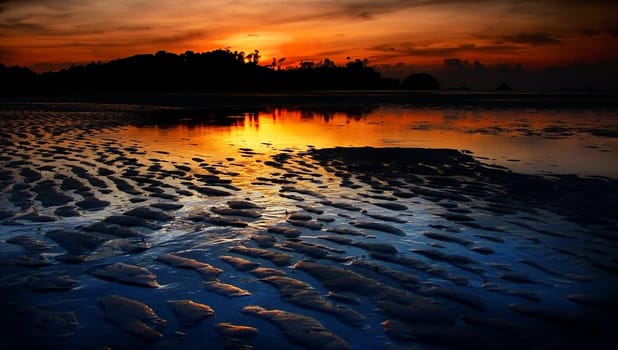 Nice sunset sky and sea at low tide in Payam island, Thailand