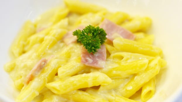 Penne spaghetti carbonara with ham