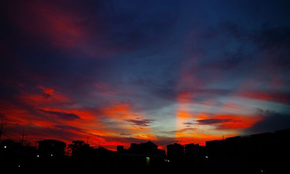 Nice sunset light shine on the sky with city silhouette