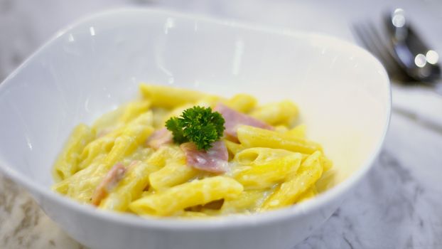 Penne spaghetti carbonara with ham