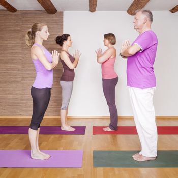 An image of some people doing yoga exercises