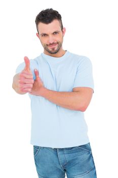 Smiling man with thumbs up on white background