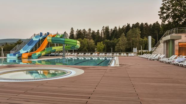 Bright aqua park constructions in swimming pool