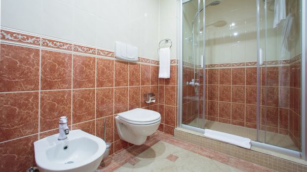 Modern bathroom interior with glass door shower