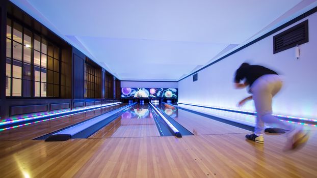 motion blur man playing bowling. Creative background