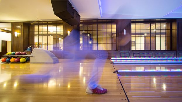 motion blur man playing bowling. Creative background