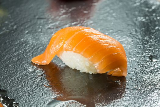 sushi with organic salmon on black background