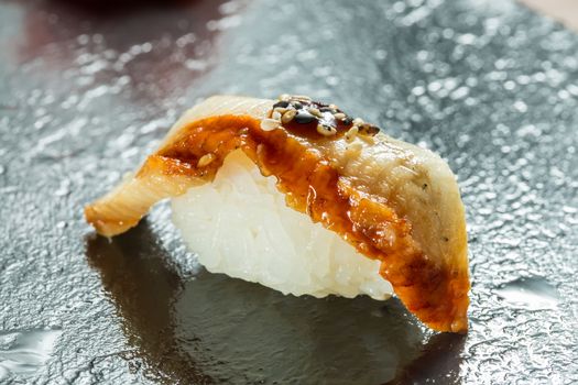 Organic Eel sushi nigiri on black background