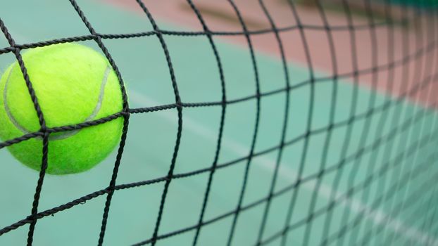 Tennis yellow ball in net. creative background