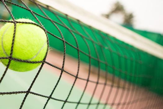 Tennis yellow ball in net. creative background