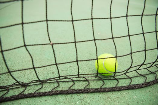 Tennis yellow ball in net. creative background