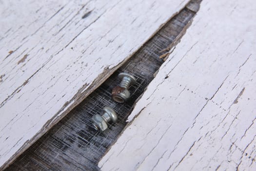 closeup on a pile of screws on old wood