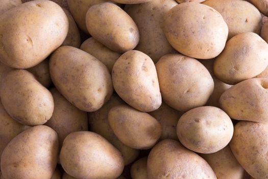 Full frame background of whole raw farm fresh golden potatoes for a delicious nutritious vegetable accompaniment