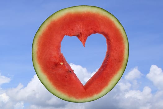 Watermelon punch a heart shape on blue sky